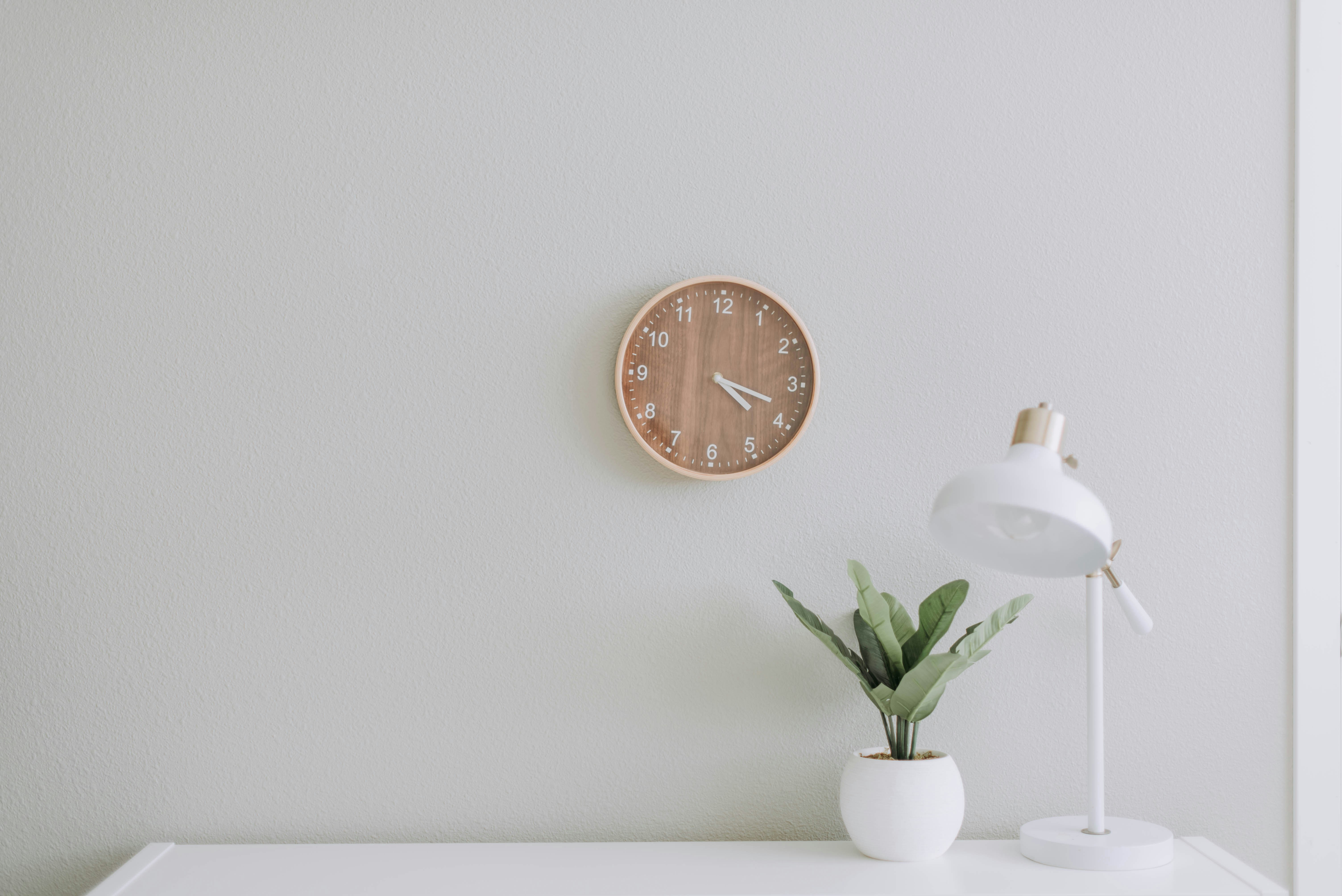 Minimal workspace with clock and plant